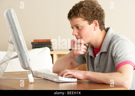 Teenage Boy in Thought Studying at Home Stock Photo