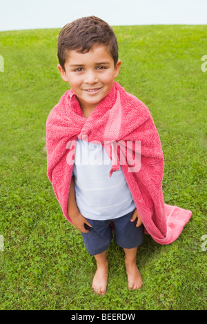 Hispanic boy wearing towel cape