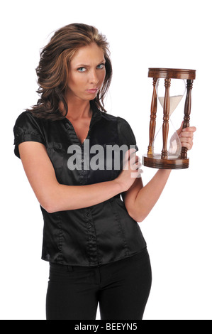 Businesswoman holding a sand timer isolated against a white background Stock Photo