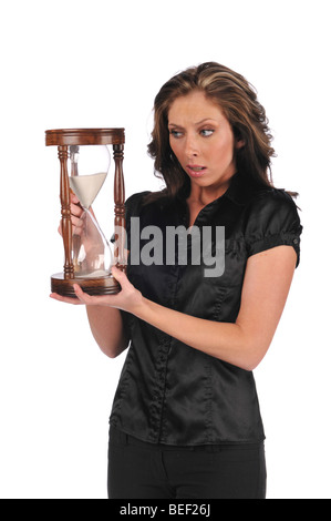 Businesswoman holding a sand timer isolated against a white background Stock Photo