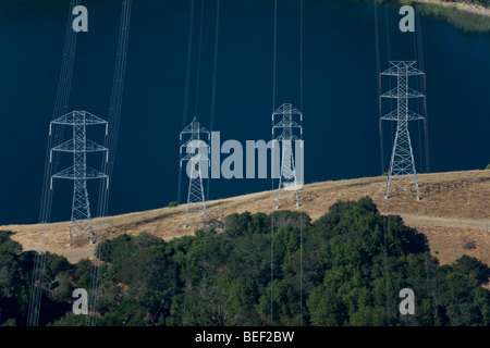 aerial view above power transmission lines towers at California reservoir Stock Photo