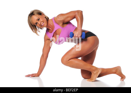 Woman working out using dumbells and isolated on white background Stock Photo