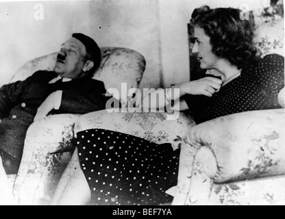 Adolf Hitler and Eva Braun relax in comfortable chairs.