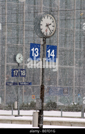 Clocks on Helsinki main railway station in winter Stock Photo