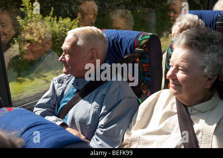 Elderly couple Passengers in a coach wearing seat belts Stock Photo