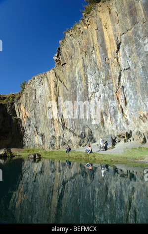 People sitting by The Blue Lake in an old quarry, above Friog village, Snowdonia National park, Gwynedd north Wales, UK Stock Photo