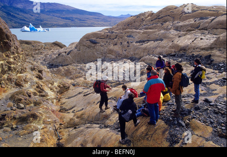 A guide gives instructions to a group of of tourists before beginning a trekking on the glacier Viedma. El Chalten. The Glaciers Stock Photo
