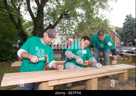 Volunteer from Harvard Pilgrim Health Care participates in a City Year project to renovate a inner city Boston charter school. Stock Photo