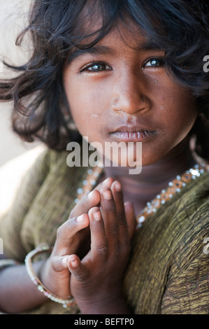 Young Indian street girl greeting with folded hands. selective focus Stock Photo