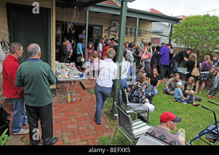 Australians enjoying Easter Sunday with a lunch time party of Hot Cross Buns and drinks in a private home and garden Stock Photo