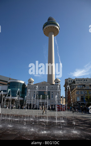 fountain water display in williamson square with the playhouse and radio city tower in the background in liverpool city centre Stock Photo