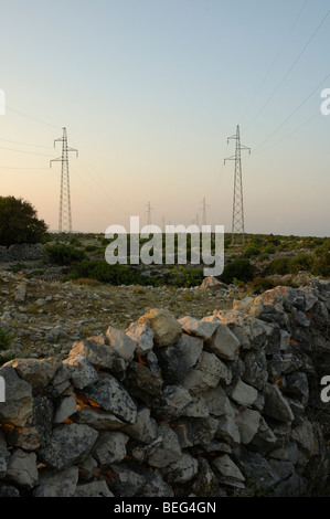 Dry-stone wall and power transmission line on sunset, Island Cres, Croatia, Europe Stock Photo