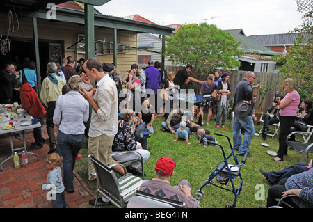 Australians enjoying Easter Sunday with a lunch time party of Hot Cross Buns and drinks in a private home and garden Stock Photo