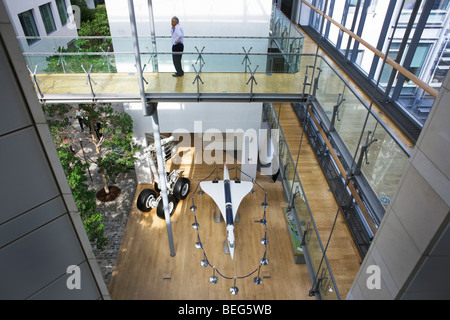 A British Airways employee makes a call in atrium at company corporate headquarters at Waterside at Harmondsworth. Stock Photo