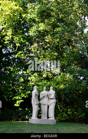 three standing figures by Henry moore in battersea park london United kingdom Stock Photo