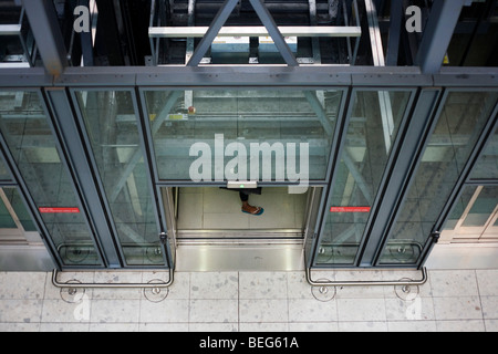 Heathrow Express lift passenger's foot and architecture at Heathrow airport's terminal 5. Stock Photo