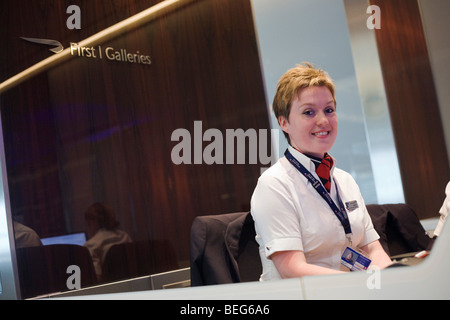 Receptionist in the British Airways Galleries First for First Class passengers at Heathrow airport's terminal 5. Stock Photo