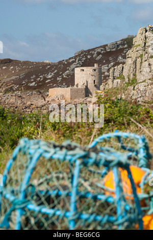 Lobster pots and Cromwell’s Castle in the background, viewed from Bryher, Isles of Scilly Stock Photo