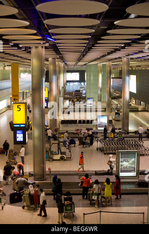 Wide aerial view of passengers awaiting baggage in the baggage reclaim hall in the arrivals of Heathrow Airport's T5 Stock Photo