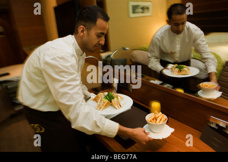 A hotel waiter delivers a meal ordered from room service in the Heathrow Airport Sofitel, attached to Terminal 5. Stock Photo