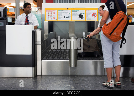 Humour during British Airways check-in at Heathrow Airport's Terminal 5. Stock Photo