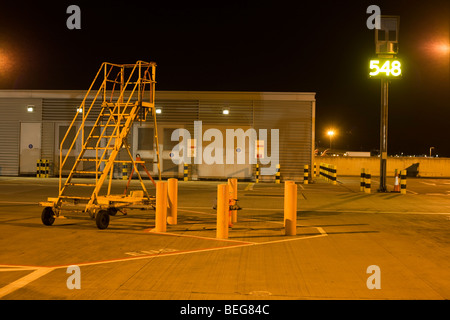 Overnight landscape of airfield movement area (apron) equipment at Heathrow Airport. Stock Photo