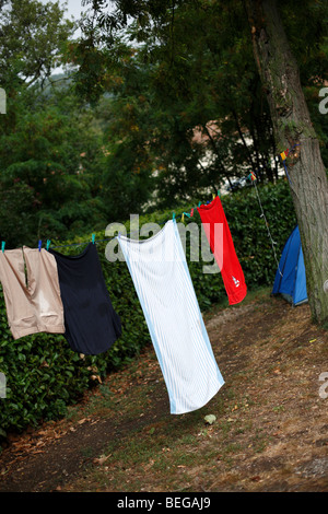 Clothing and towels hanging on a line at a campsite in Sospel in southern France Stock Photo