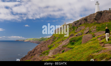 Female tourist hiking to Cape Spear lighthouse most easterly point of North America in Newfoundland on the Atlantic ocean Stock Photo