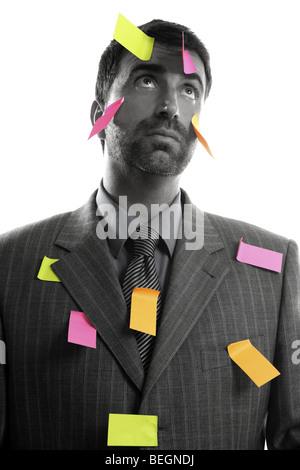 Businessman full of memo stock message notes over white studio background Stock Photo