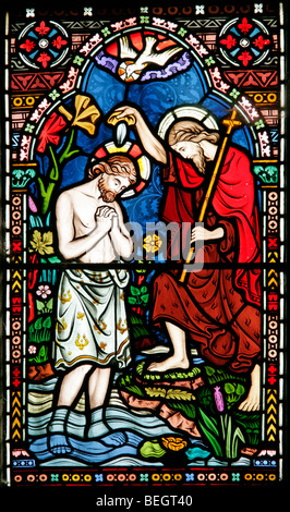 A stained glass window by William Warrington depicting the baptism of Jesus Christ, Church of St Mary the Virgin, Gunthorpe, Norfolk Stock Photo