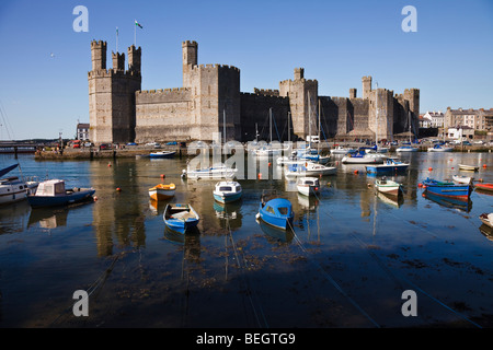 Caernarfon Castle and boats moored on the River Seiont, Gwynedd, Wales Stock Photo