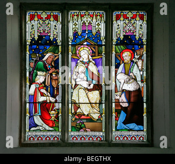 A stained glass window by Mayer & Co. depicting the Adoration of the Magi; St Andrew's Church, Brinton, Norfolk Stock Photo