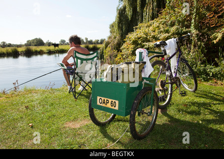 Man travels on bicycle, relaxing in green hammock, surfing Internet on  smartphone, listening music on headphones in forest near Stock Photo - Alamy