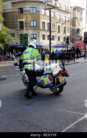 Metropolitan Police officer with motor bike blocking road at the Angel Islington after an accident London England UK Stock Photo