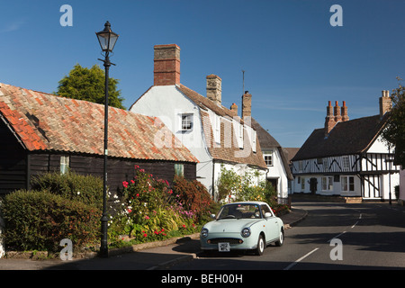 England, Cambridgeshire, Huntingdon, Houghton village St Ives Road timber framed houses with Nissan figaro car parked outside Stock Photo