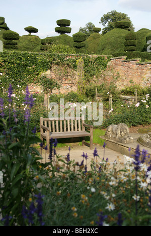 Estate of Tatton Park, England. Afternoon sunshine view of an empty bench in Tatton Park Rose Garden. Stock Photo