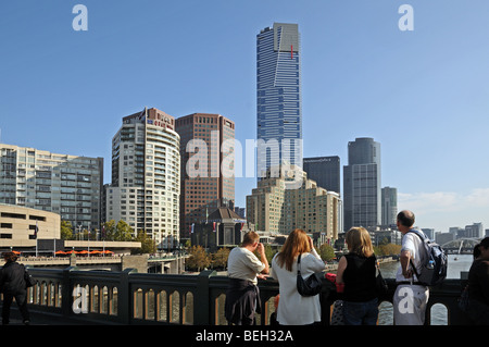 Tourist enjoy view down Yarra River from Princes Bridge Melbourne Australia with southbank high rise buildings including Eureka Stock Photo