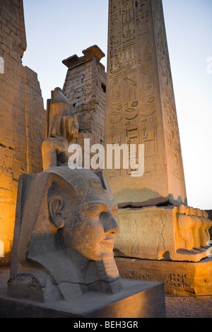 Illuminated Entrance of Luxor Temple with Ramesses II Statue and Obelisk, Luxor, Egypt Stock Photo