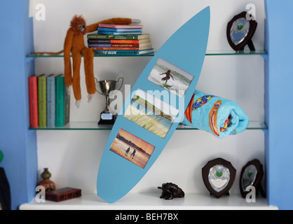 surfboard shaped photo frame in boys bedroom Stock Photo