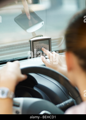 Rear view of woman typing on gps. Selective focus Stock Photo