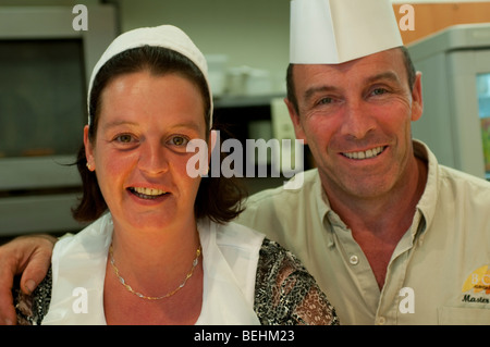 Man and woman bakers in a bakery shop, Beziers, France Stock Photo