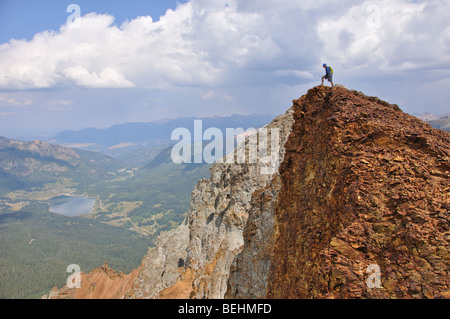 A hiker stands on top of East Sheep mountain in the San Juan mountains of Colorado Stock Photo