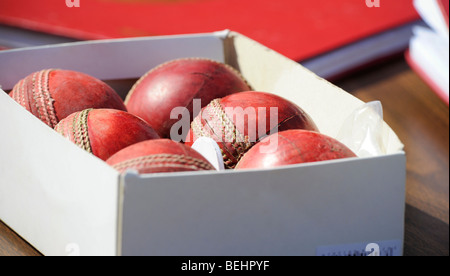 A box of six  cricket balls on a score keepers table. Stock Photo