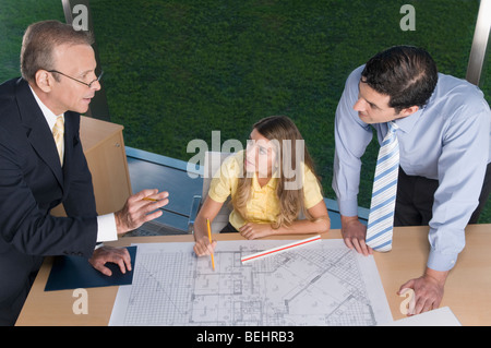 Architects discussing a blueprint in an office Stock Photo