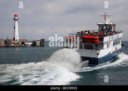 A Ferry and Wawatam Lighthouse on Lake Huron in Saint Ignace Michigan Great Lakes close up closeup  hi-res Stock Photo