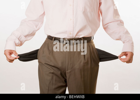 Man turning out his empty pockets Stock Photo