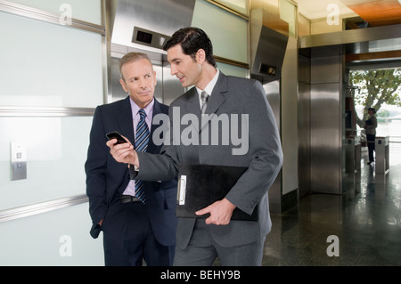 Businessmen walking in a corridor Stock Photo