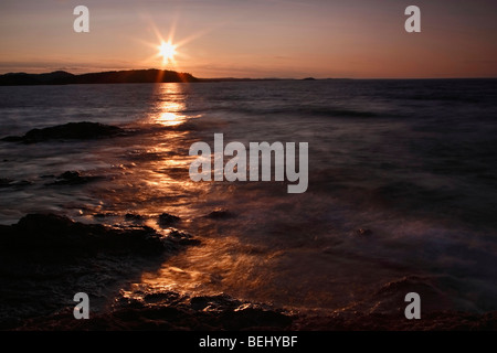 Dramatic Lake Superior summer orange sunset in Michigan USA top view from above Great Lakes nobody none waves on beach from above hi-res Stock Photo