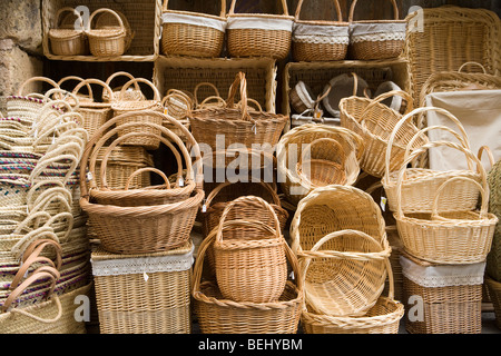 Stacked variety of traditional wickerwork baskets outside shop, Segovia, Spain Stock Photo