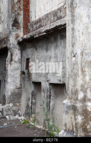 Deserted broken building concrete wall with window abandoned ruins nobody old vintage fashioned wallpapers wallpaper vertical in USA hi-res Stock Photo